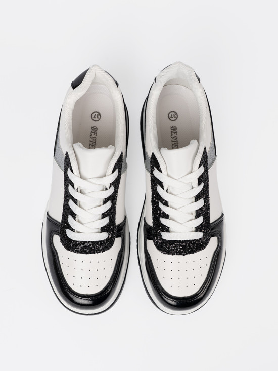 Sneakers nere e bianche con dettagli argentati lucidi