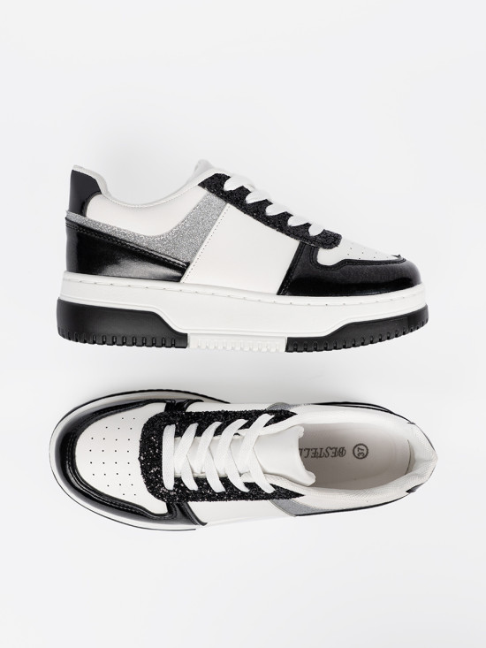 Sneakers nere e bianche con dettagli argentati lucidi