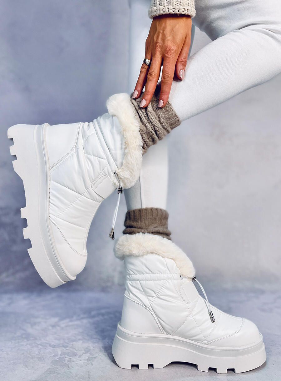 Scarpe imbottite da neve bianche su una piattaforma alta