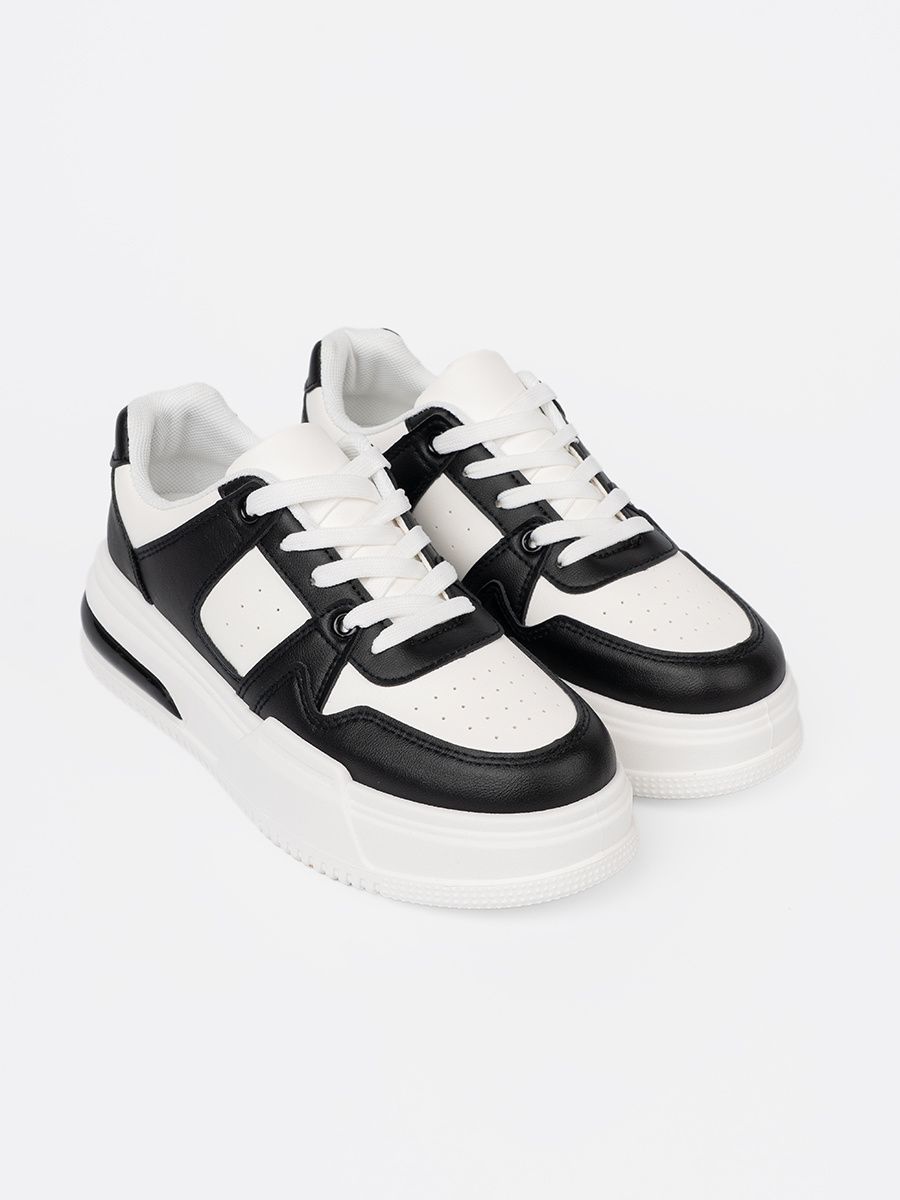 Sneakers neri e bianchi alla moda con suola spessa
