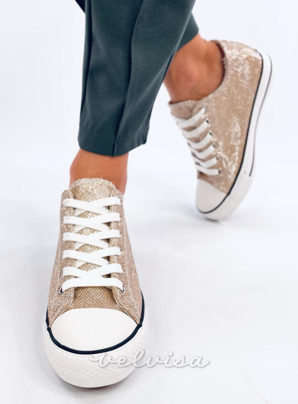 Sneakers dorate con tacco nascosto