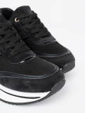 Sneakers nere moderne con dettagli lucidi