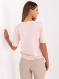 Elegante maglione rosa chiaro con applicazione
