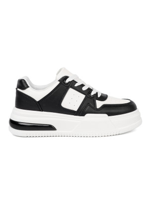 Sneakers neri e bianchi alla moda con suola spessa